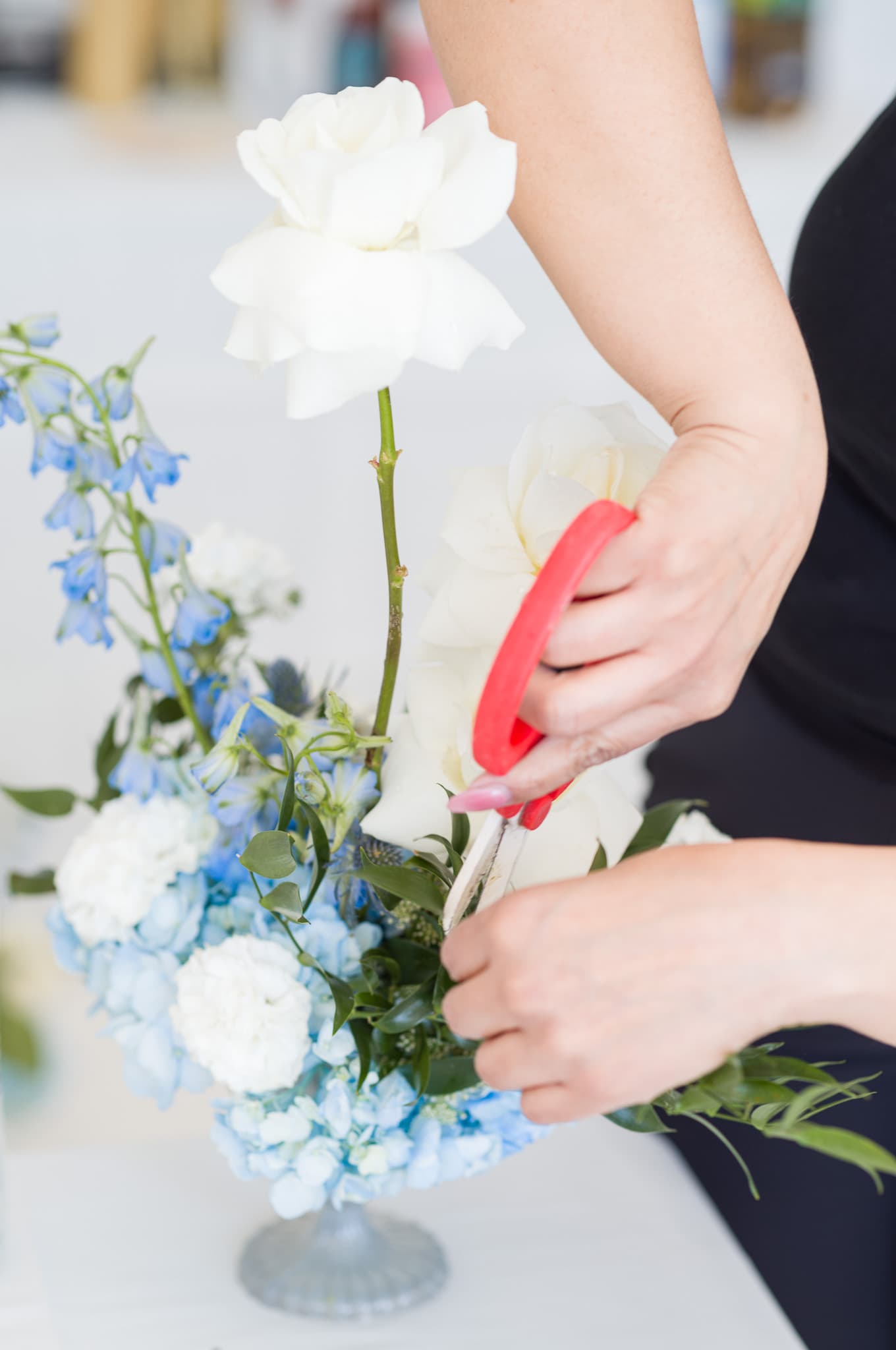 Trimming white roses for the centerpiece arrangements