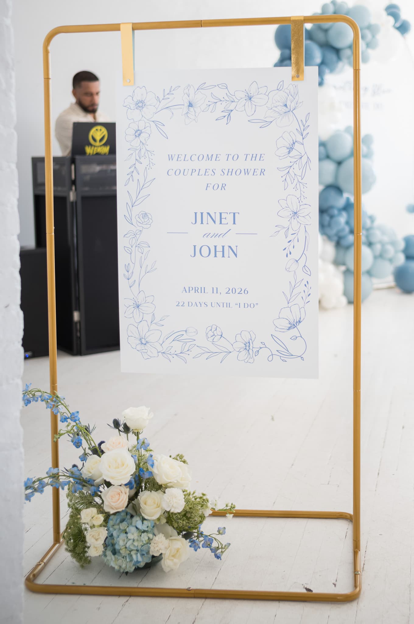 The welcome sign framed in gold with the balloon arch visible in the background